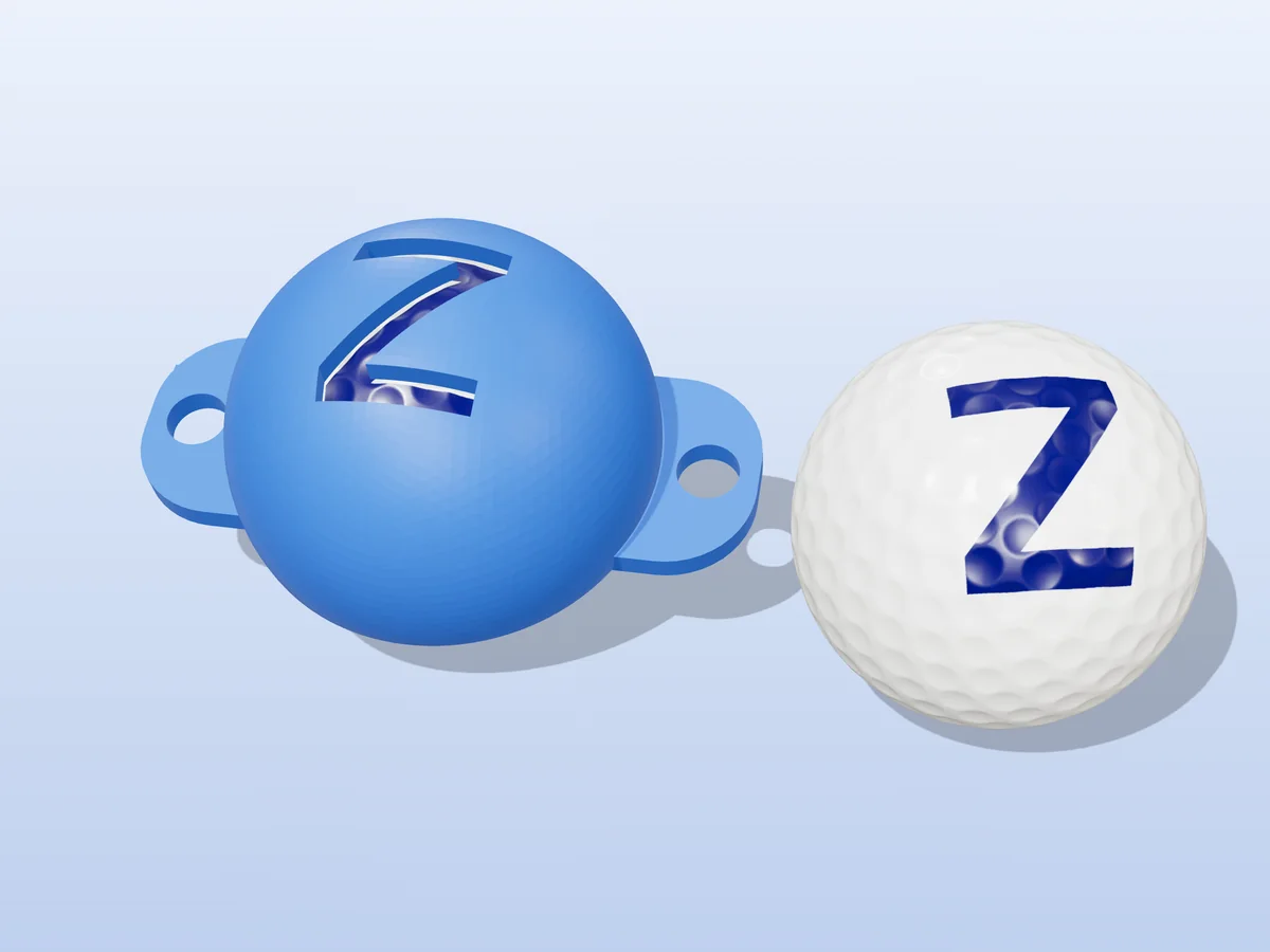 3D render of a blue 3D-printed golf ball stencil with the letter Z cut through it, sitting on a golf ball, next to a ball marked with a blue Z