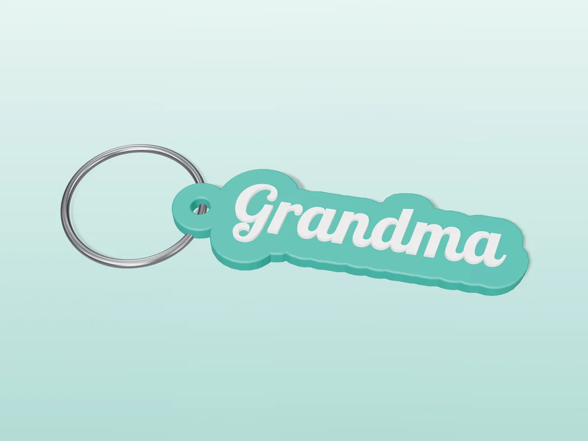 3D render of a teal and white 3D-printed Grandma keychain with a steel split ring through its hole