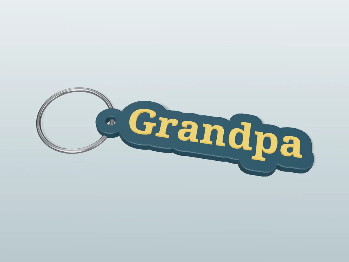 3D render of a dark teal and gold 3D-printed Grandpa keychain with a steel split ring through its hole