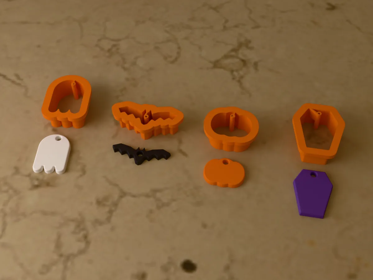 3D render of four 3D-printed orange polymer clay earring cutters (ghost 30 mm, bat 38 mm, pumpkin 26 mm and coffin 32 mm) with the clay earring pieces they cut in front