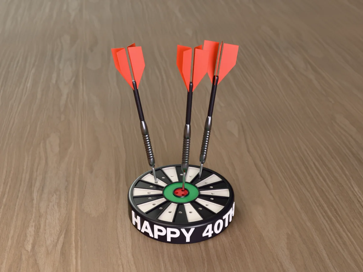 3D render of the printed personalized dart holder: a round black case with HAPPY 40TH raised in white round its side, a black and white dartboard face with a green ring and red bullseye, and three darts standing in it