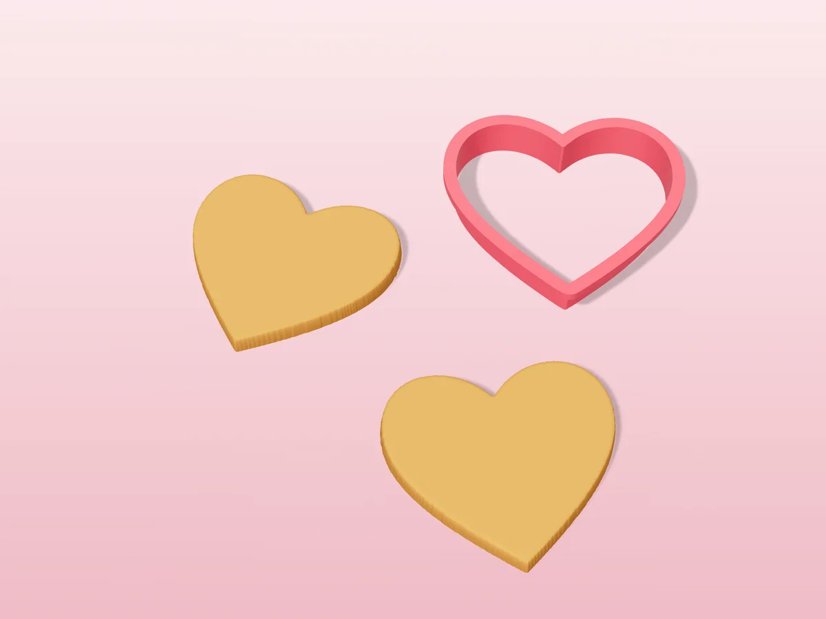 3D render of a pink 3D-printed heart cookie cutter next to two golden baked cookies in the same shape