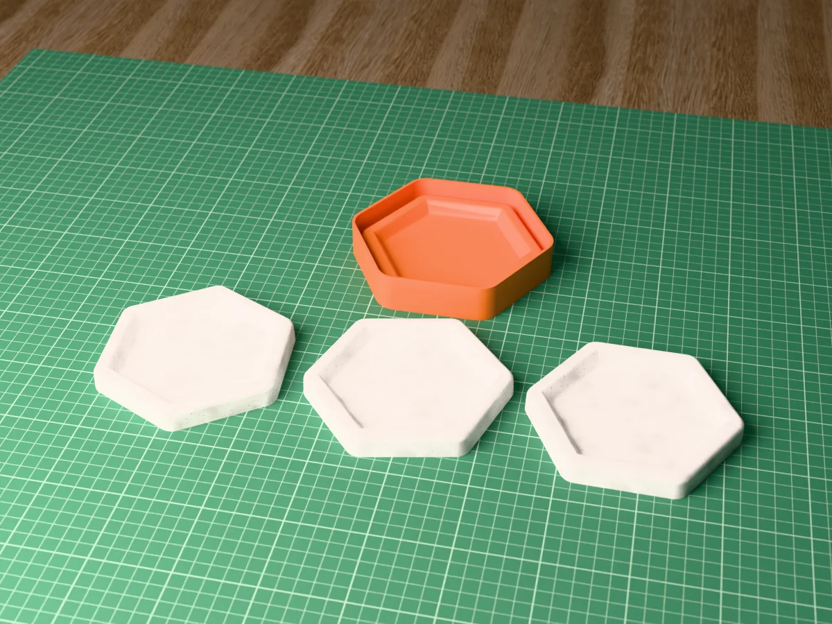 3D render of the printed hexagon caster for a silicone catch-all tray mold, with three grey concrete hexagon trays in front