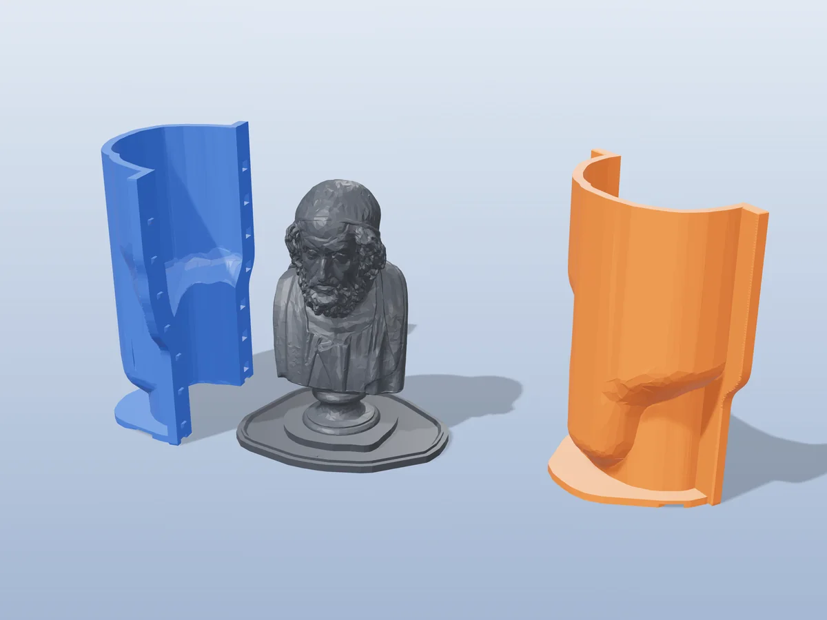 3D render of the Homer bust master fused on its printed charcoal base, between the orange and blue hugging shell halves