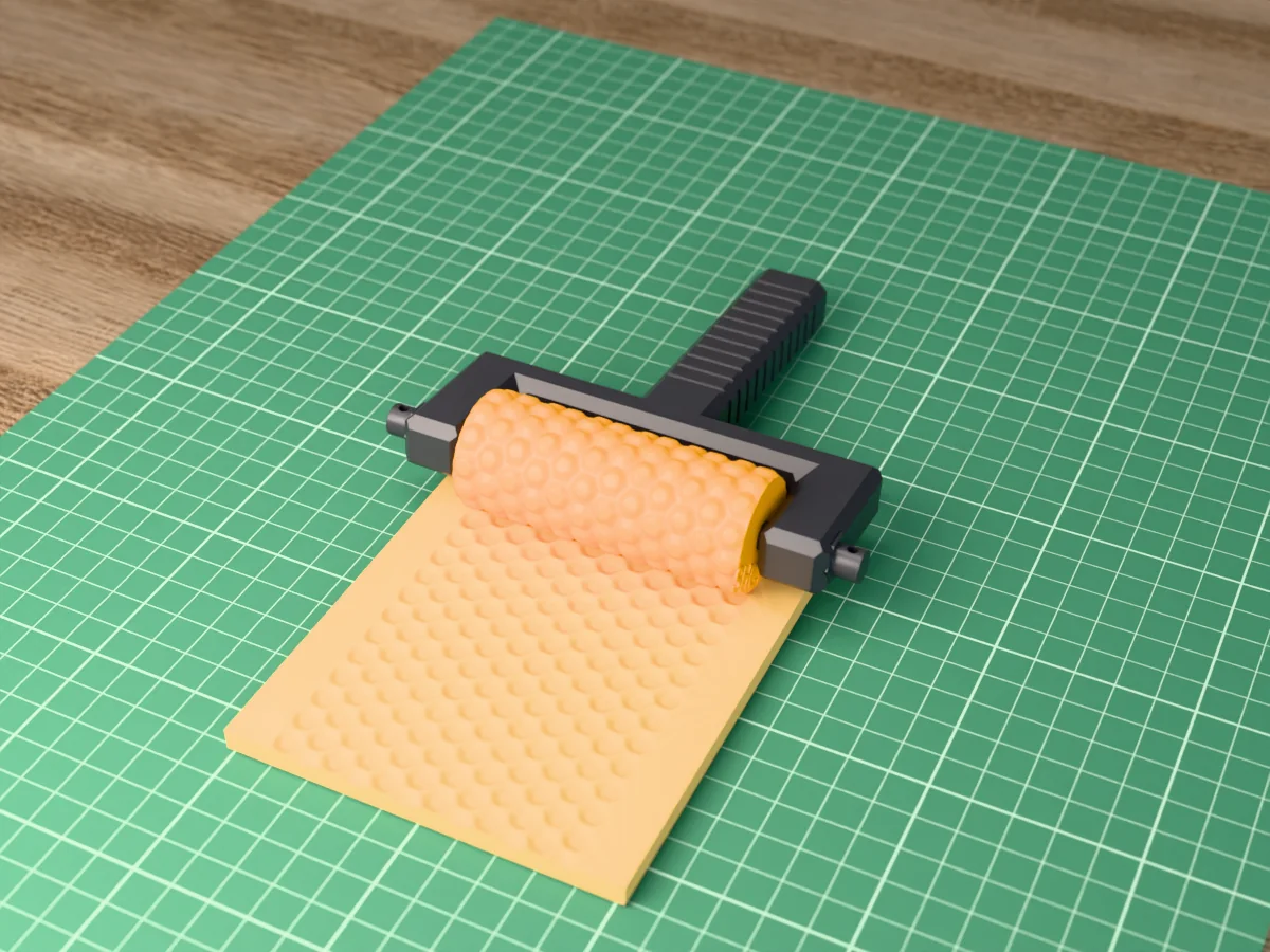3D render of the printed honeycomb texture roller in its dark fork handle, resting on a slab of clay it has pressed with honeycomb cells