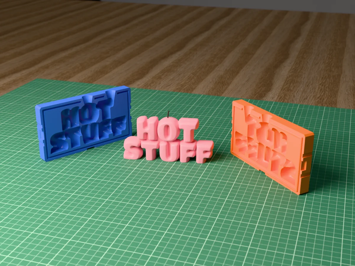 3D render of a HOT STUFF bubble letter candle between the two printed halves of its rigid orange and blue mold