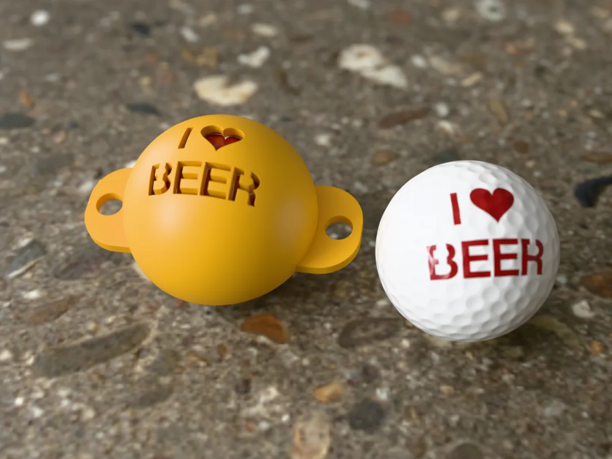 3D render of an amber 3D-printed golf ball stencil with I (heart) BEER cut through it, sitting on a golf ball, next to a ball marked with I (heart) BEER in red