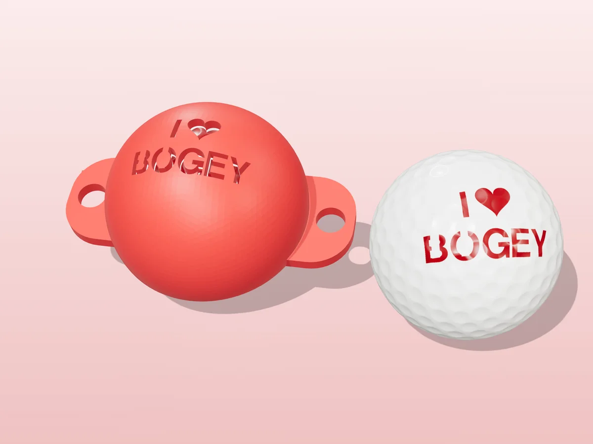 3D render of a red 3D-printed golf ball stencil with I (heart) BOGEY cut through it, sitting on a golf ball, next to a ball marked with I (heart) BOGEY in red
