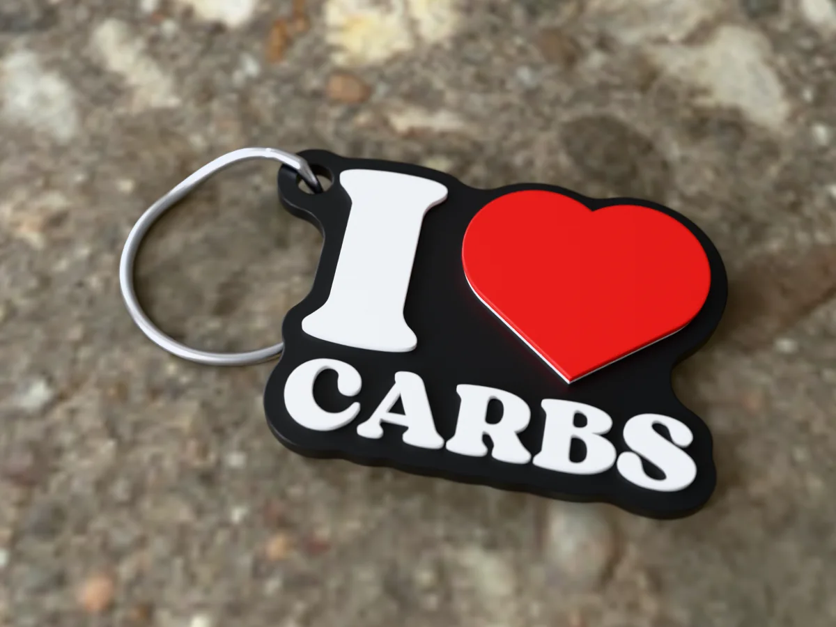 3D render of a black, white and red 3D-printed I love carbs keychain with a steel split ring through its hole