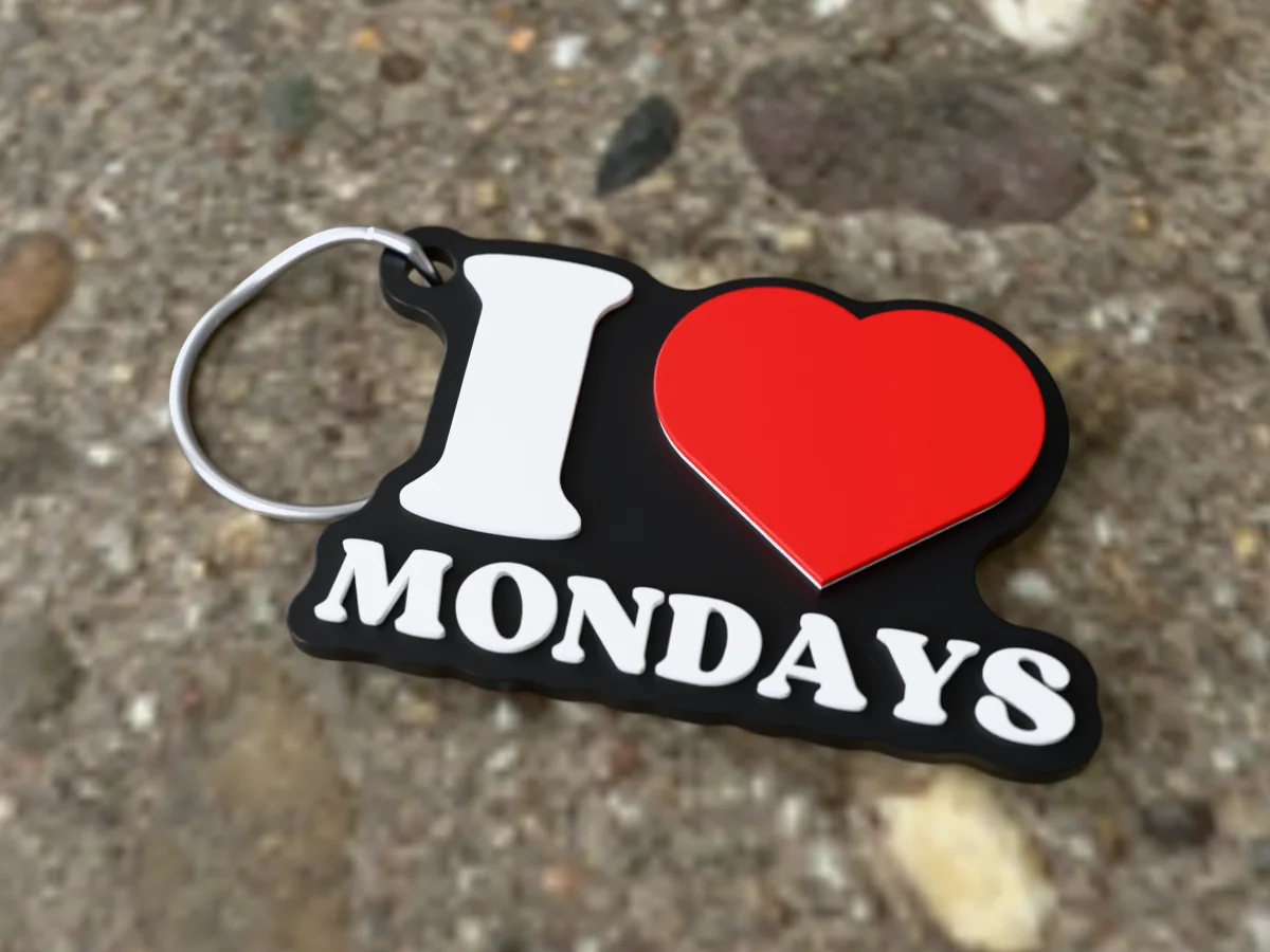 3D render of a black, white and red 3D-printed I love Mondays keychain with a steel split ring through its hole