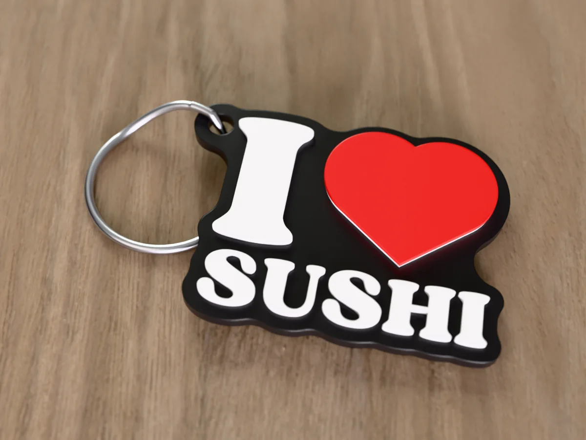 3D render of a black, white and red 3D-printed I love sushi keychain with a steel split ring through its hole