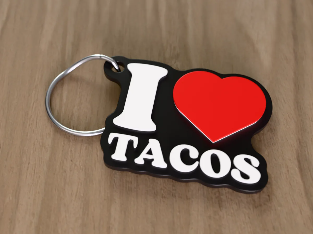 3D render of a black, white and red 3D-printed I love tacos keychain with a steel split ring through its hole