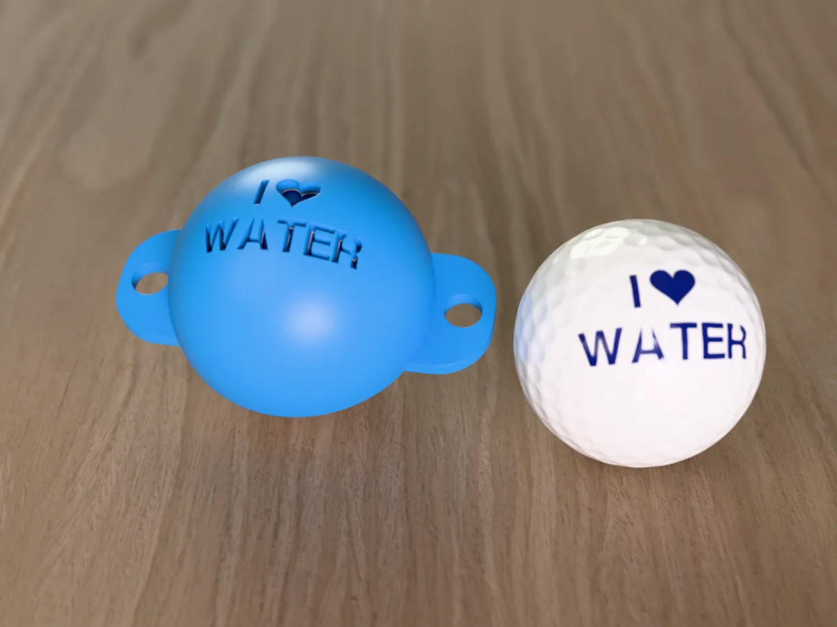 3D render of a blue 3D-printed golf ball stencil with I (heart) WATER cut through it, sitting on a golf ball, next to a ball marked with I (heart) WATER in blue