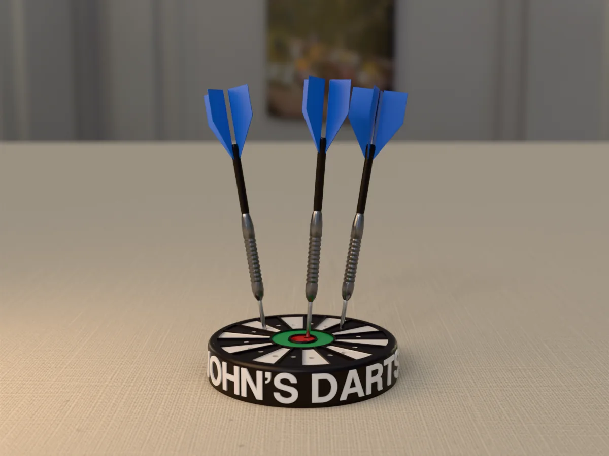 3D render, low view of the printed JOHN'S DARTS dart holder on a table, the name raised in white round the black case and three darts with blue flights standing in it
