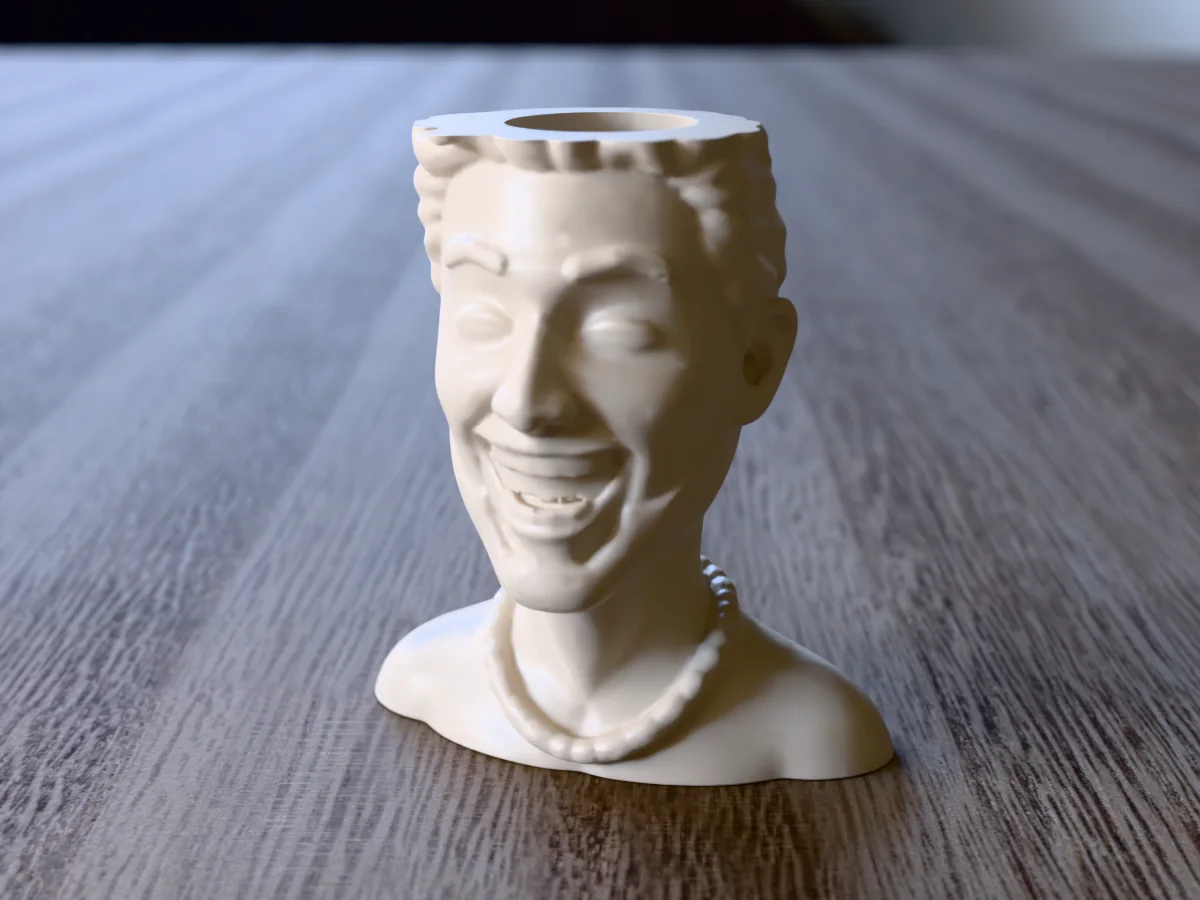 3D render of a 3D-printed laughing head planter, a cartoon head made with the head generator