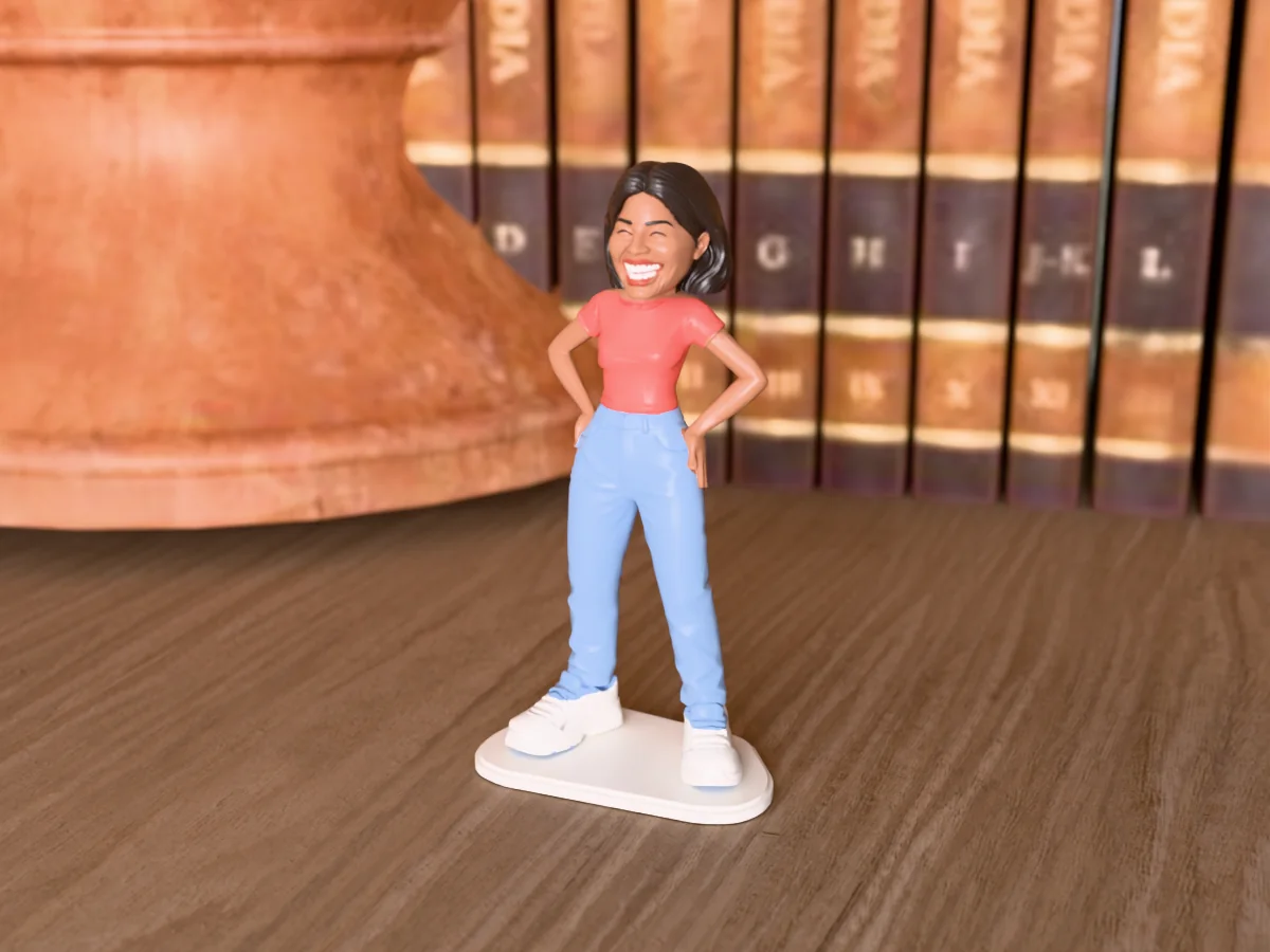 3D render of a 3D-printed mini figure of a woman with long dark hair, laughing with her eyes shut, painted in 6 colours, on a table