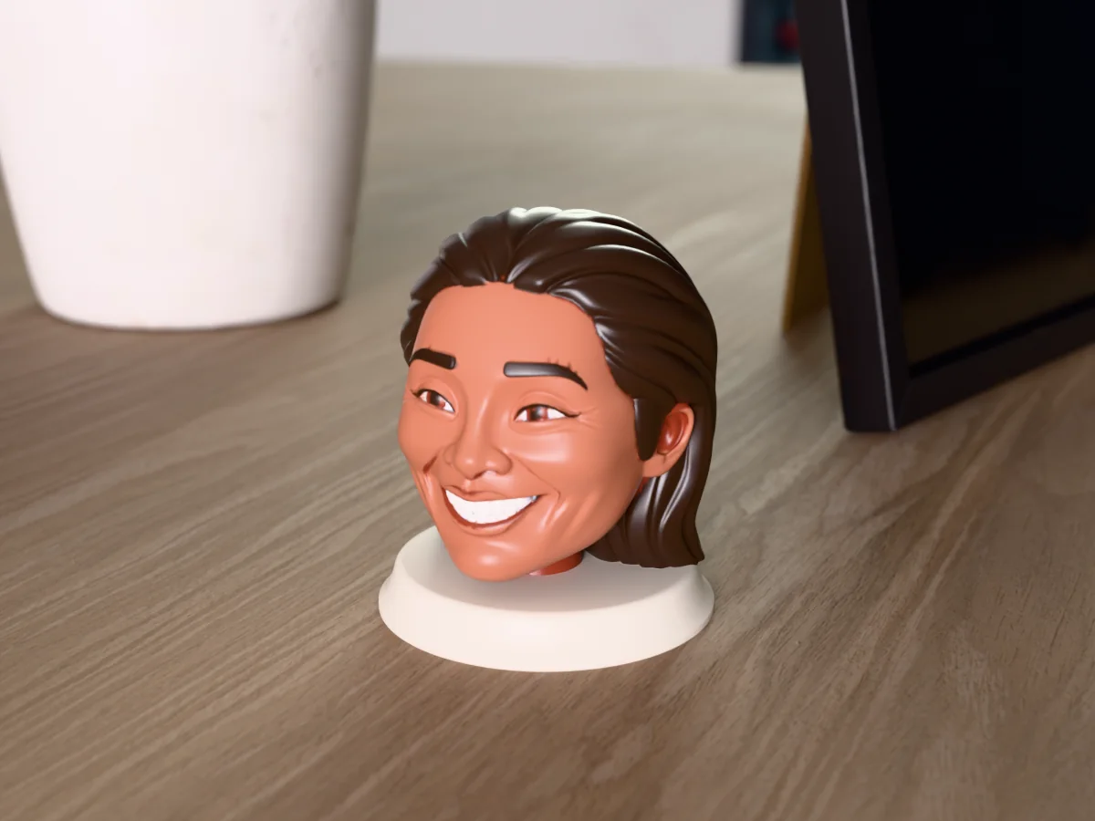 3D render of a 3D-printed bust of a beaming woman with long dark wavy hair, painted in 6 colours, on a table