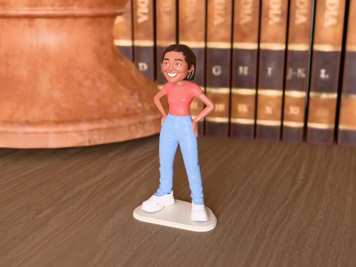 3D render of a 3D-printed mini figure of a beaming woman with long dark wavy hair, painted in 6 colours, on a table