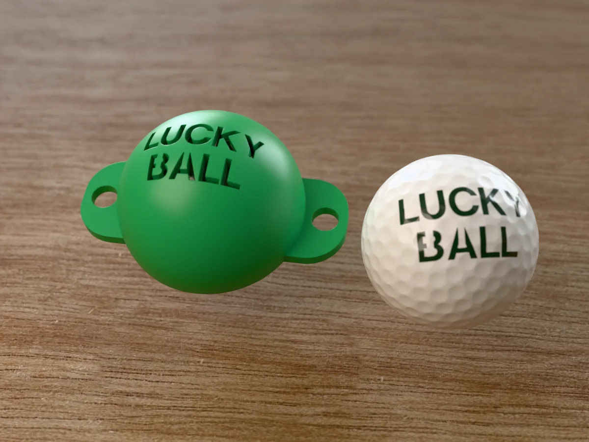 3D render of a green 3D-printed golf ball stencil with LUCKY BALL cut through it, sitting on a golf ball, next to a ball marked with LUCKY BALL in green