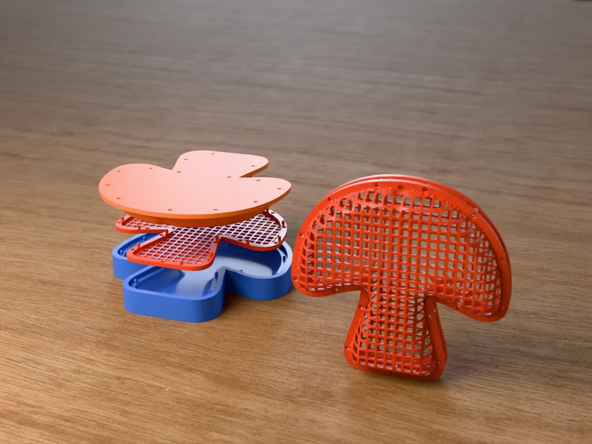 3D render of a red square-mesh mushroom with a hanging hole in its cap, beside the blue cavity, the flat net and the orange plug of the press that forms it