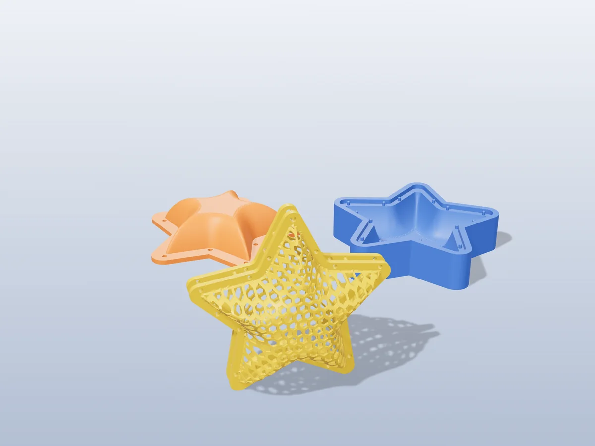 3D render of a gold honeycomb mesh star ornament, closed from two formed halves, in front of the orange and blue press halves that form it