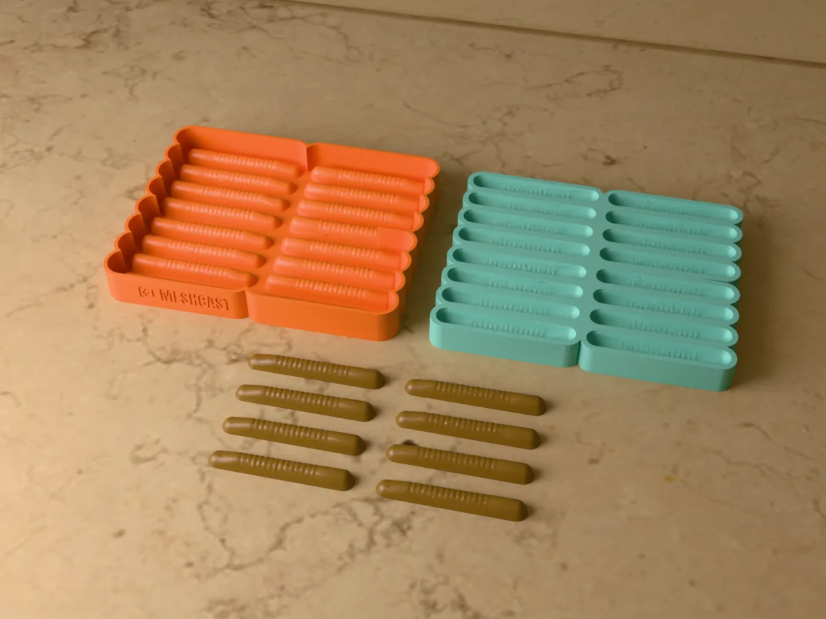 3D render of the printed caster for a sixteen-cavity silicone ned rig lure mold beside the silicone mold it pours, with brown soft plastic ned baits in front