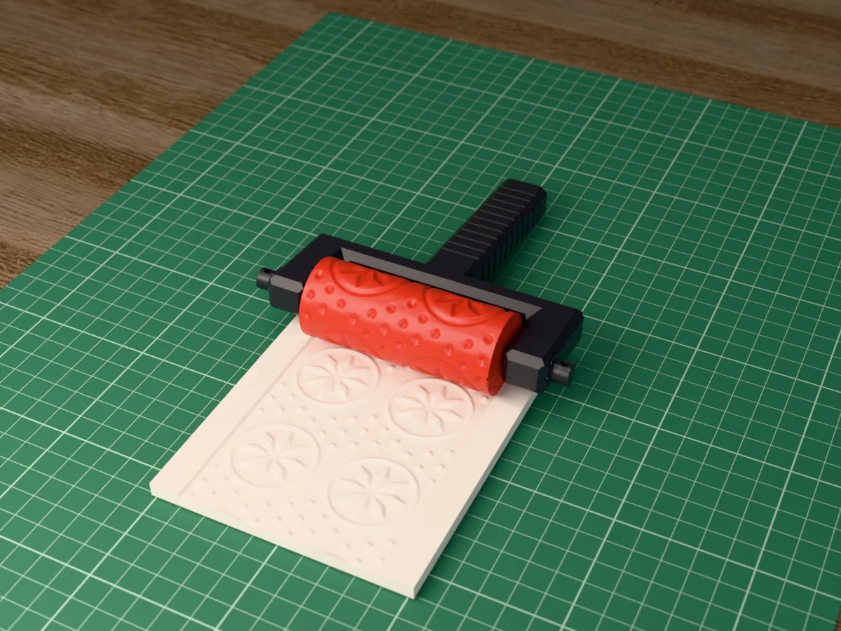 3D render of the printed nordic star texture roller in its dark fork handle, resting on a slab of clay it has pressed with a Norwegian star sweater