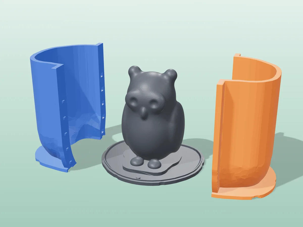 3D render of the owl master fused on its printed charcoal base, between the orange and blue hugging shell halves