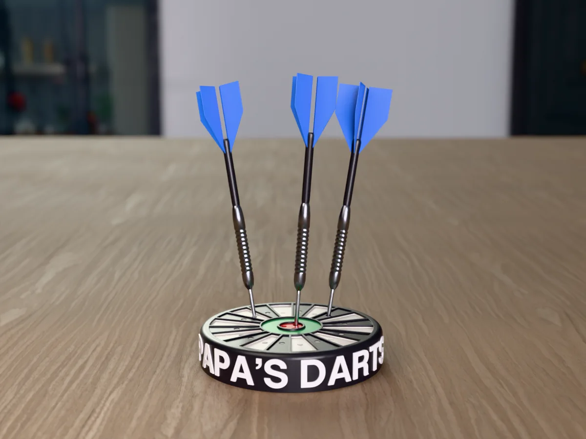 3D render, low view of the printed PAPA'S DARTS dart holder on a table, the name raised in white round the black case and three darts with blue flights standing in it