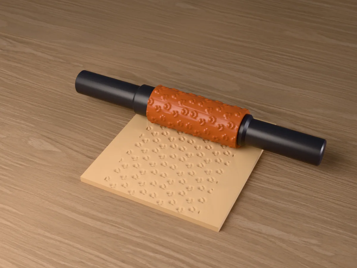 3D render of the printed paw print textured rolling pin, its patterned sleeve between two dark handles, resting on a slab of clay it has pressed with paw prints