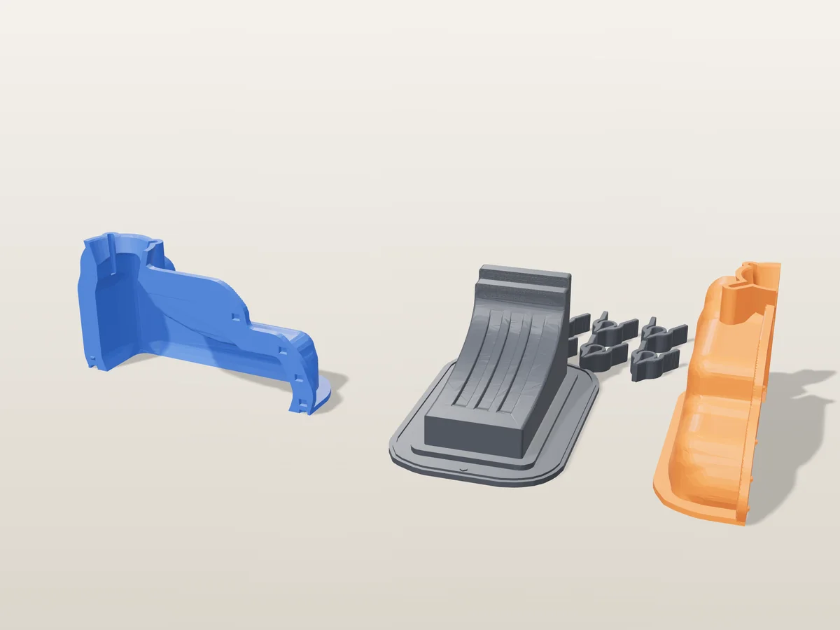 3D render of the fluted block corbel master fused on its printed charcoal base, between the orange and blue shell halves, with the charcoal clamps behind