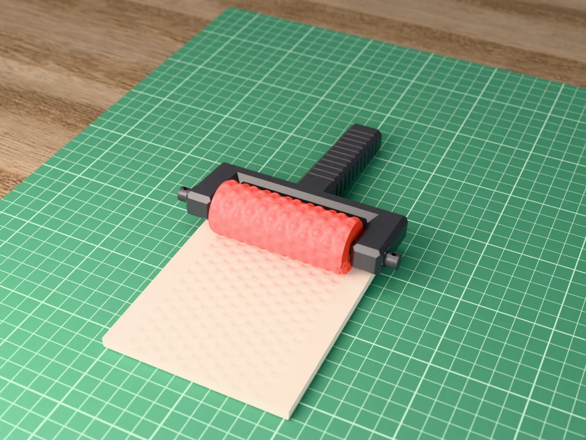 3D render of the printed polka dot texture roller in its dark fork handle, resting on a slab of clay it has pressed with polka dots