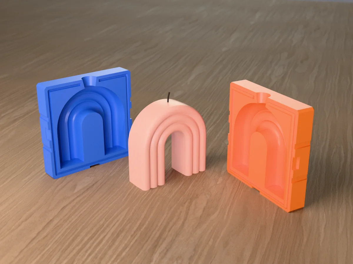 3D render of a blush pink rainbow arch candle of three rounded bands between the two printed halves of its rigid blue and orange mold