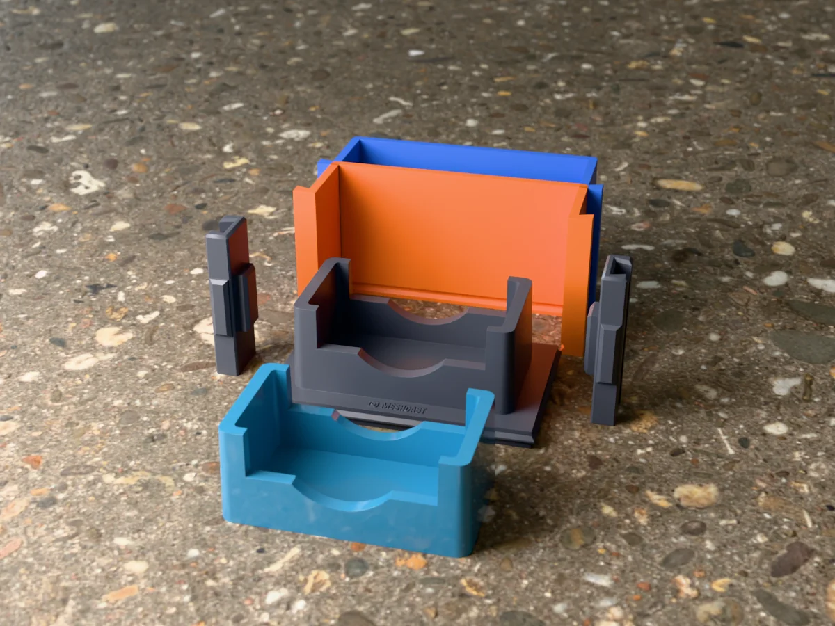 3D render of the coaster holder master on its printed base between the orange and blue walls, with a blue resin coaster holder in front