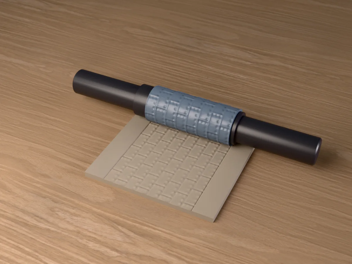 3D render of the printed riveted metal plate textured rolling pin, its patterned sleeve between two dark handles, resting on a slab of clay it has pressed with riveted steel plates