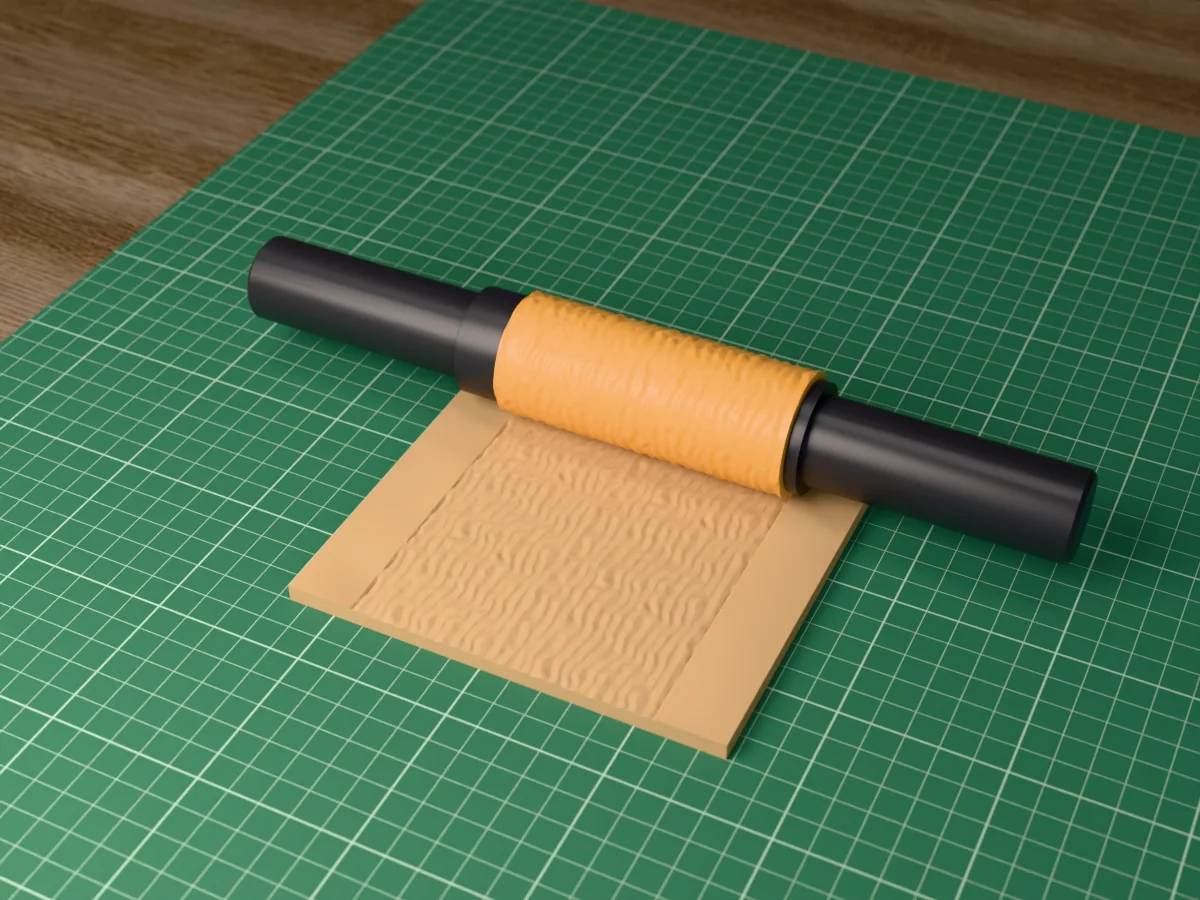 3D render of the printed sand ripple textured rolling pin, its patterned sleeve between two dark handles, resting on a slab of clay it has pressed with wind-blown sand ripples