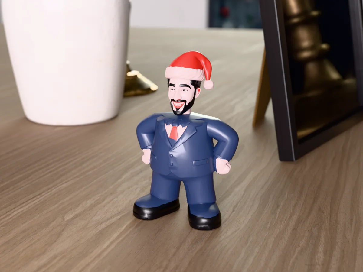 3D render of a 3D-printed mini figure of a guy with a black beard in a Santa hat, painted in 6 colours, on a table