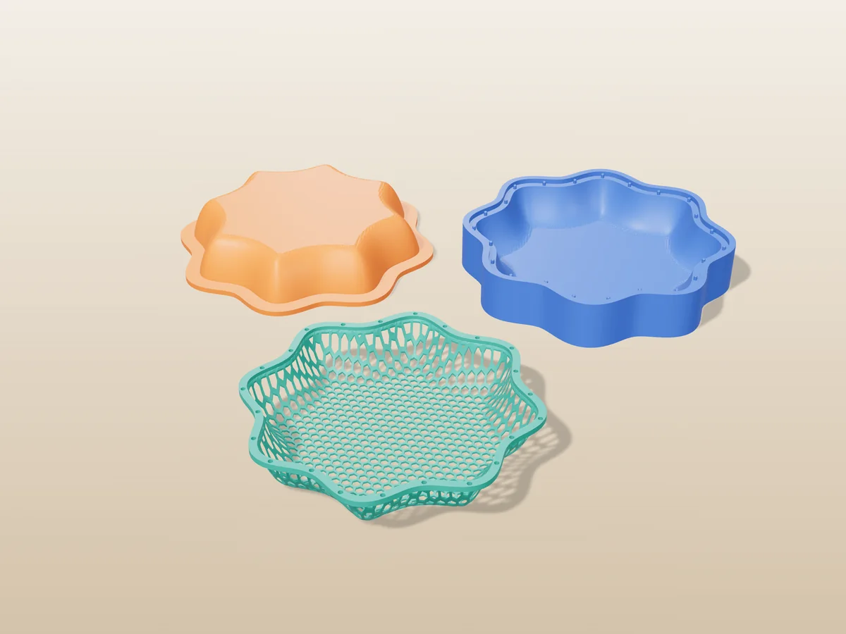3D render of a teal scalloped honeycomb mesh bowl in front of the orange and blue press halves that form it
