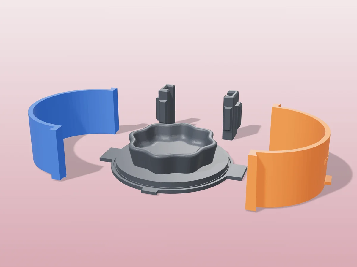 3D render of the scalloped trinket dish master fused on its printed charcoal base, between the orange and blue round walls, with the charcoal clamps behind