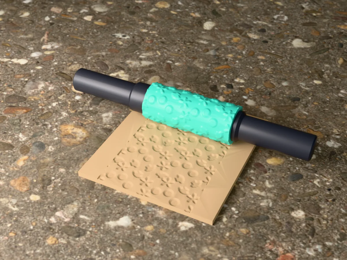 3D render of the printed seashell textured rolling pin, its patterned sleeve between two dark handles, resting on a slab of clay it has pressed with seashells and starfish