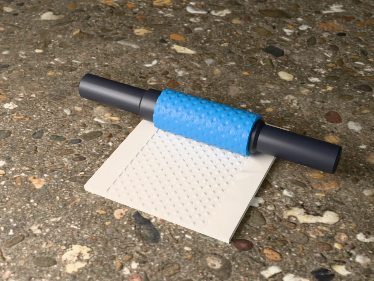 3D render of the printed seigaiha wave textured rolling pin, its patterned sleeve between two dark handles, resting on a slab of clay it has pressed with seigaiha waves