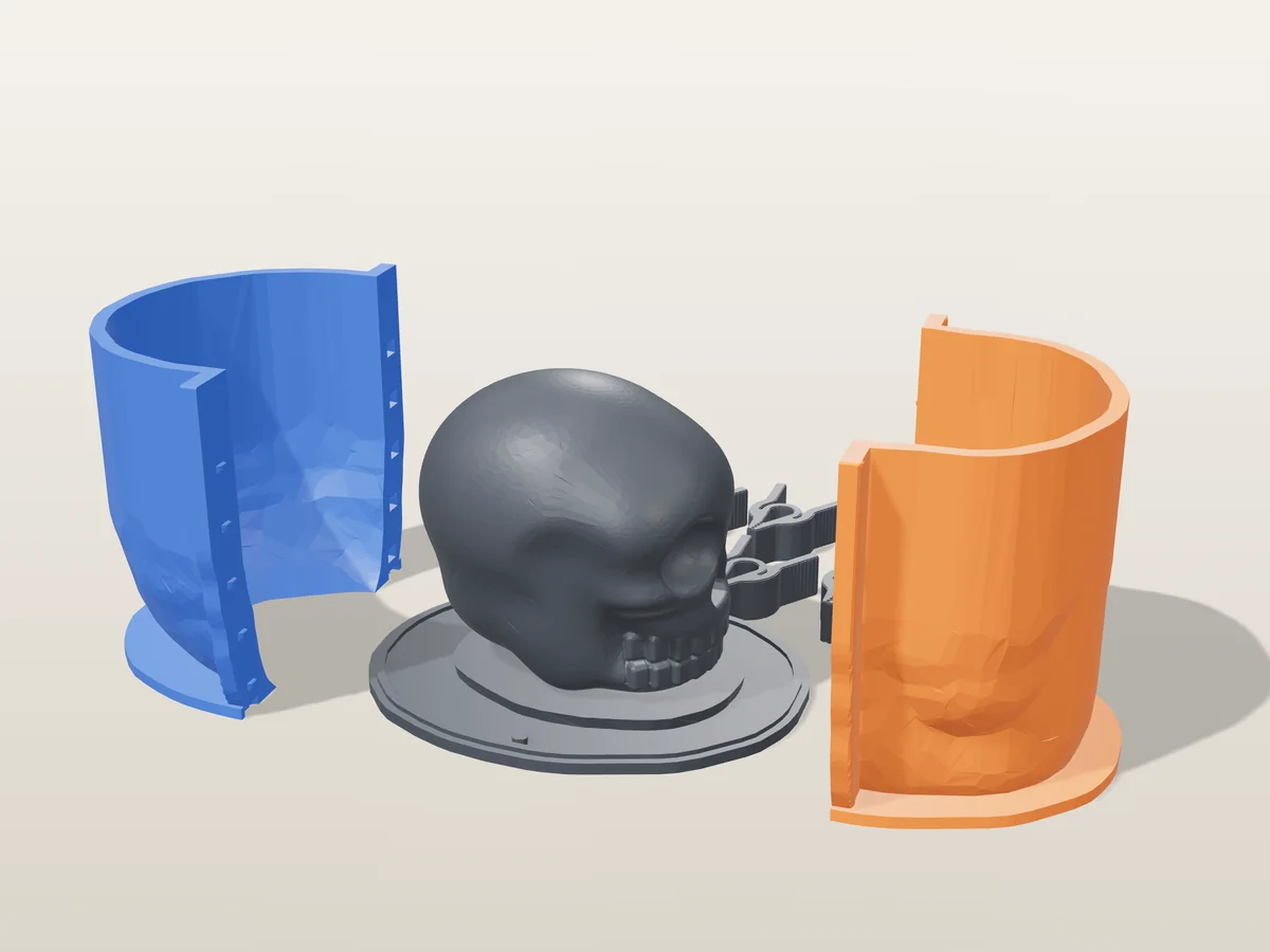 3D render of the skull master with deep eye sockets and teeth, fused on its printed charcoal base, between the orange and blue hugging shell halves