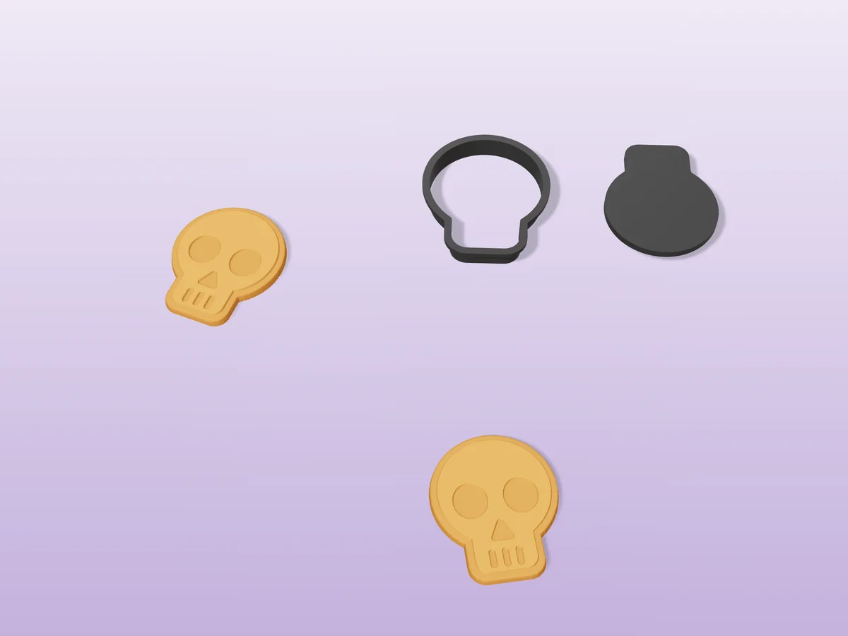 3D render of a black 3D-printed skull emoji cookie cutter and stamp next to two golden baked cookies with the face pressed in