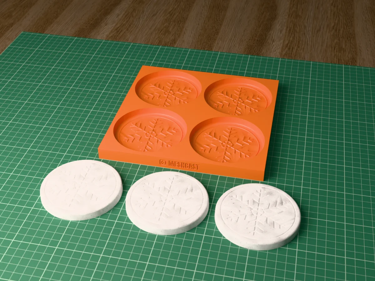 3D render of a printed tray with four snowflake coaster cavities, with three grey concrete coasters with an engraved snowflake beside it