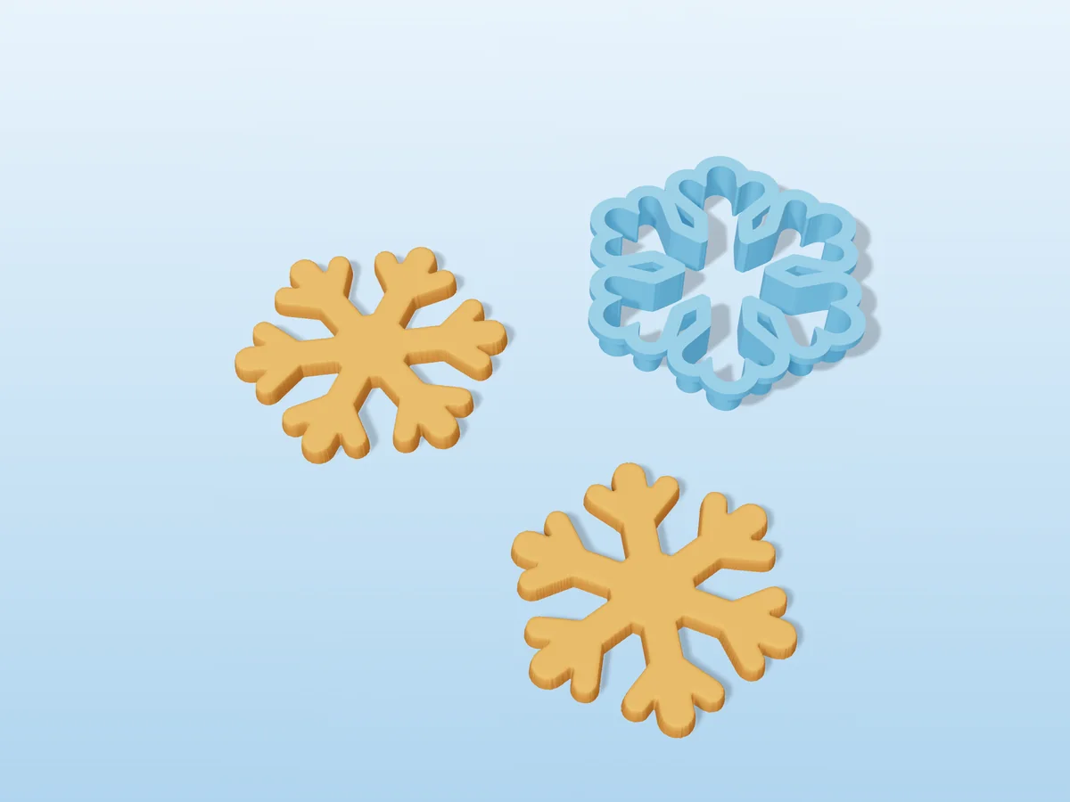 3D render of a light blue 3D-printed snowflake cookie cutter next to two golden baked cookies in the same shape