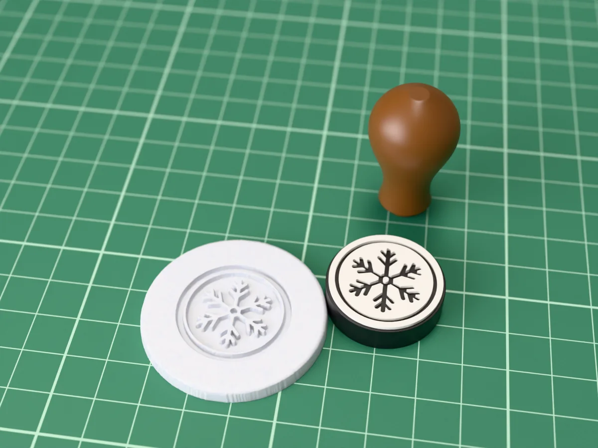 3D render of the printed snowflake wax seal stamp, face up next to its brown handle, and a round wax seal it has pressed