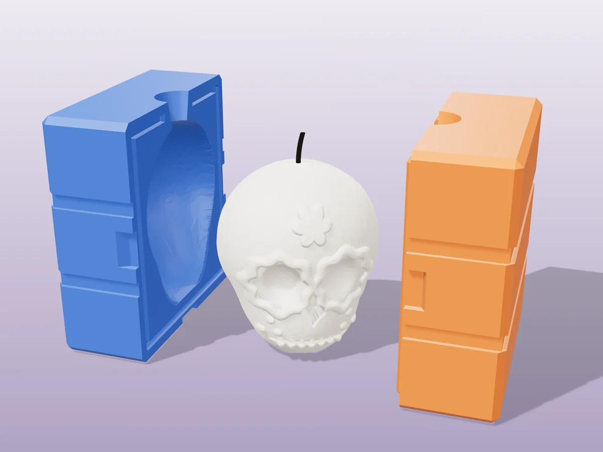3D render of a white sugar skull candle with petal-ringed eyes between the two printed halves of its rigid blue and orange mold