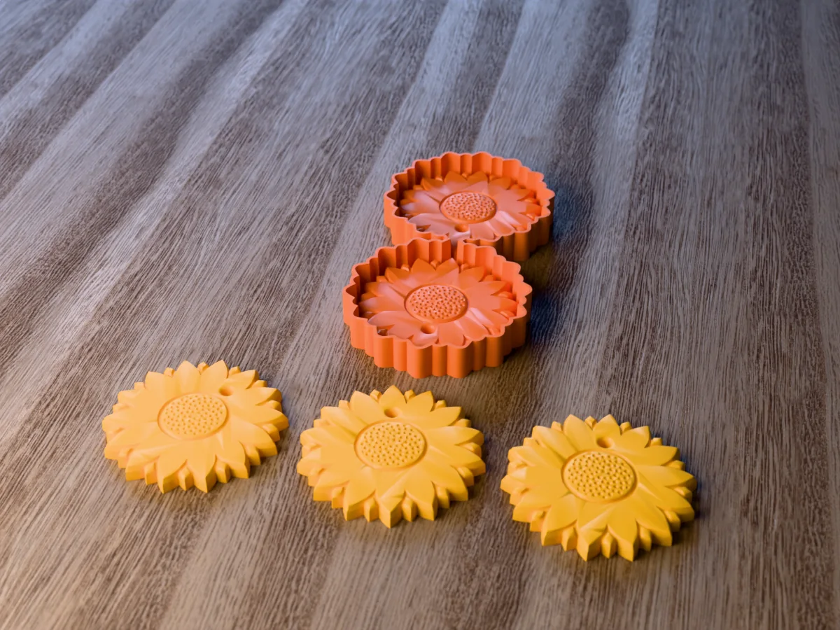 3D render of the printed caster for a two-cavity sunflower freshie mold, with three yellow sunflower car freshies with a seeded centre in front
