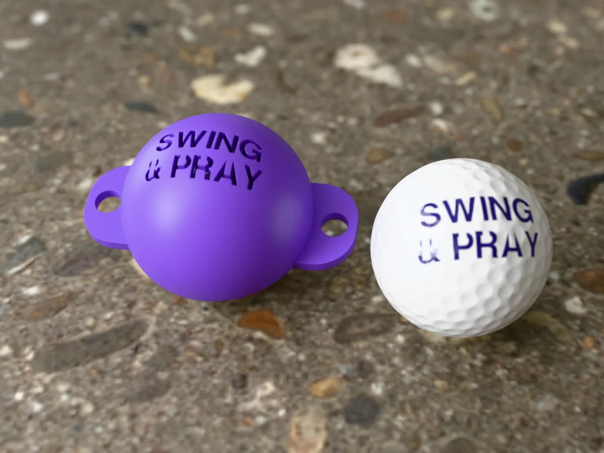 3D render of a purple 3D-printed golf ball stencil with SWING & PRAY cut through it, sitting on a golf ball, next to a ball marked with SWING & PRAY in purple