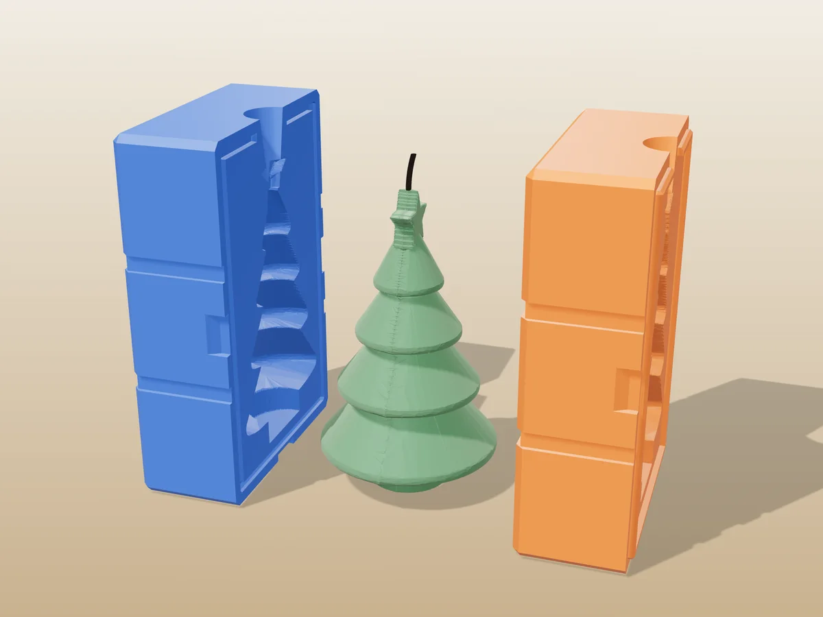 3D render of a green tiered Christmas tree candle with a star on top between the two printed halves of its rigid blue and orange mold